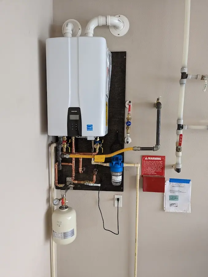 Professional plumber installing copper piping in a Peshtigo home